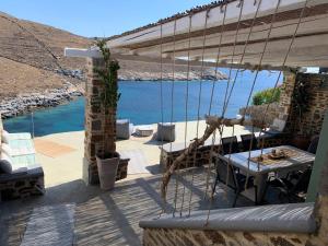 a patio with a view of the water at Kythnos Beach house in Kithnos