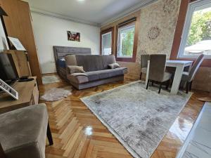 a living room with a couch and a table at ALOHA apartment in Novi Pazar