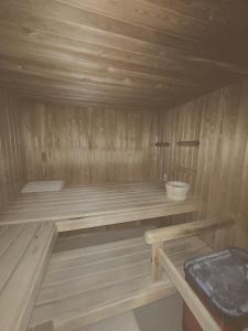 a wooden sauna with a bench in a room at Wasserfall - Zentrum - Balkon - Seeblick - Küche in St. Moritz