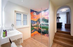 فندق روزنفيلا في سالزبورغ: حمام به لوحة كبيرة على الحائط