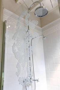 a shower with a shower curtain in a bathroom at Carriage House in quiet ecological garden in Antwerp