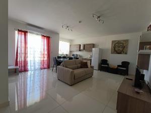 a living room with a couch and a kitchen at Crescent Court F in St. Paul's Bay