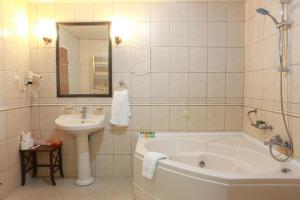 a bathroom with a tub and a sink at Balcova Termal Hotel in İzmir