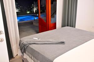 a bed with a towel on it next to a door at Vacation house Rubi in Dubrovnik