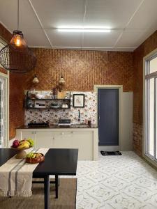 a kitchen with a table and a counter top at Casablanca Homestay in Āīzawl