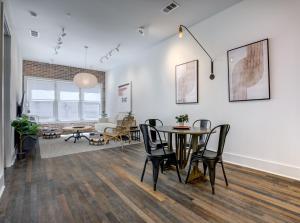a dining room and living room with a table and chairs at Loft condo w parking & patio Apt 101 in Atlanta