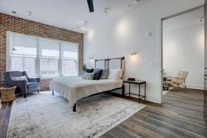 a bedroom with a bed and a brick wall at Loft condo w parking & patio Apt 101 in Atlanta
