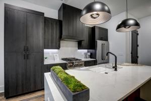 a kitchen with black cabinets and a counter with grass on it at Loft condo w parking & patio Apt 101 in Atlanta +30 photos