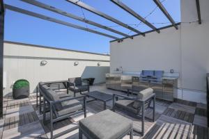 a patio with chairs and tables in a building at Loft condo w parking & patio Apt 101 in Atlanta