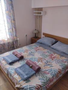 a bedroom with a bed with two pillows on it at Гери2 in Arbanasi