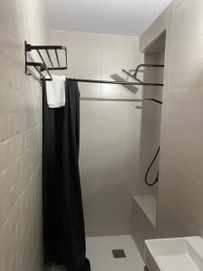 a bathroom with a shower with a black shower curtain at Estudios Barbate Playa 4 in Barbate
