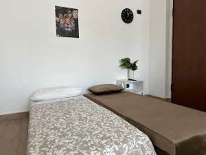 מיטה או מיטות בחדר ב-Fleming20 Cimmino- San Siro, Rho Fiera, Milano Centro