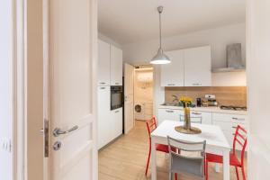 a kitchen and dining room with a table and chairs at Four Luxury Apartment in Palermo