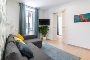 a living room with a couch and a window at Four Luxury Apartment in Palermo