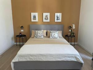 a bedroom with a large bed with two side tables at Sunset 221 Cagliari in Cagliari