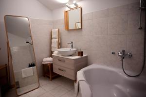 a bathroom with a tub and a sink and a mirror at Vacation house Rubi in Dubrovnik +30 photos