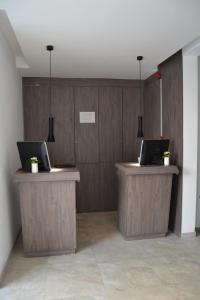 a lobby with two desks with laptops on them at The Helmet Hotel in Brussels