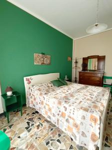 una camera con letto e parete verde di Affittacamere San Rocco ad Aramengo