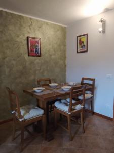 a dining room with a wooden table and chairs at APPARTAMENTO PIEVE ANTICA 
