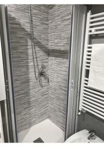 a bathroom with a shower with a toilet and a sink at Lingotto35 in Turin +9 photos