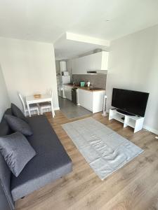 a living room with a couch and a tv at Casa Saudade in Charneca