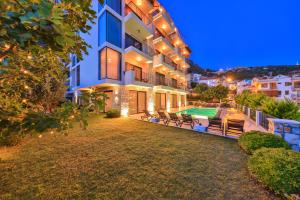 an exterior view of a house with a swimming pool at Carruba Boutique Hotel in Kaş
