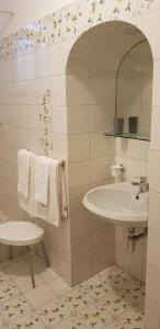 a bathroom with a sink and a mirror and towels at Relais Zio Vincenzo Casa Positano in Positano