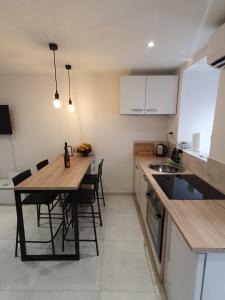 a kitchen with a wooden table and some chairs at Vacation Liberation Apartment in Split