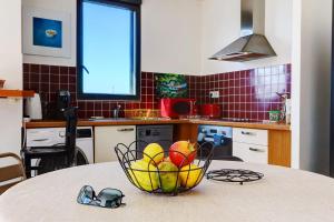 a bowl of fruit on a table in a kitchen at La Terrasse - Apt T3 Saint Pierre in Saint-Pierre
