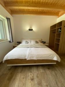 a bedroom with a large bed and wooden floors at Apart Montis in See