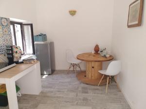 Il Regno delle due Sicilie في ريبوستو: مطبخ مع طاولة وكراسي في غرفة