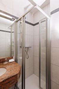 a bathroom with a shower and a sink at Naturhotel Blaubach in Blaubach