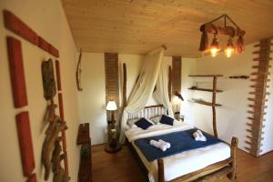 a bedroom with a bed with two stuffed animals on it at Villa Vejini cabin in Mamkoda