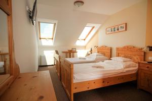 A bed or beds in a room at Diófa Panzió