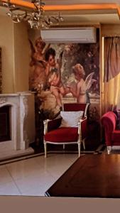 a living room with a painting of angels on the wall at NoVel 1 Luxury apt Katerini in Katerini