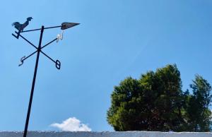 a weather vane in the snow with a bird on it at La Caseta de Cadaqués in Cadaqués