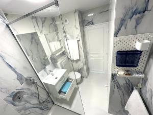 a bathroom with a shower and a sink and a toilet at Studio Trip In Paris - Gare de l'Est in Paris