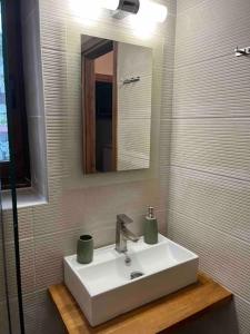 a bathroom with a white sink and a mirror at Μιτάτο Οίτη in Pávliani