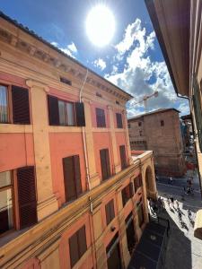 Blick auf ein Gebäude mit der Sonne am Himmel in der Unterkunft Casa Nina Bologna Centro in Bologna