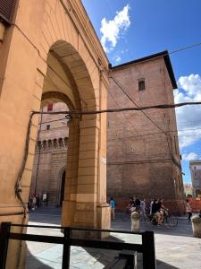 un gran edificio con un arco delante de él en Casa Nina Bologna Centro en Bolonia