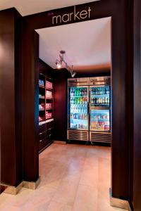 a large refrigerator with drinks inside of a store at Courtyard Houston/Brookhollow in Houston