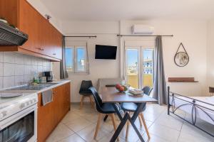 a kitchen with a table and a dining room at Studio on the closest beach to the city! in Amoudara Herakliou