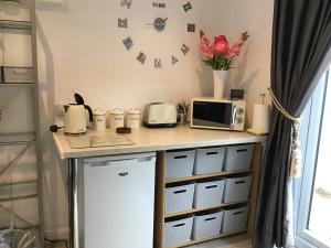 a kitchen with a counter top with a microwave at The Fields in Worcester