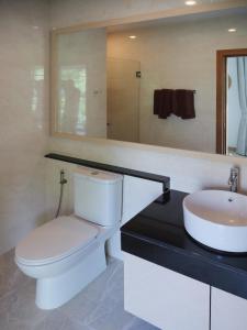 a bathroom with a toilet and a sink at Karon beach apartment & sea view pool in Ban Karon