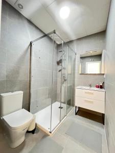 a bathroom with a shower and a toilet and a sink at Acogedor Infanta Mercedes in Madrid