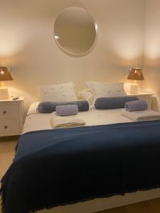 a bedroom with a large bed with a mirror on the wall at La Casetta di Gloria in Lumbarda