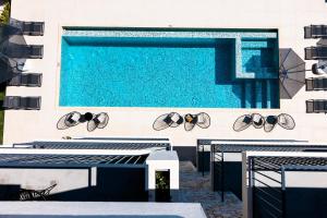 a swimming pool with sunglasses on the side of a building at Carruba Boutique Hotel in Kaş
