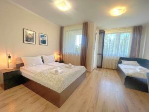 a bedroom with a large bed and a window at Арборо Боровец Гардънс Д35 in Borovets