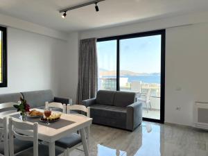 a living room with a table and chairs and a couch at Diamond DREAM in Sarandë