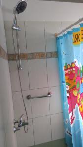 a shower with a blue shower curtain in a bathroom at HOLIDAYS APARTMENT ΜΕΣΣΗΝΗ in Messini